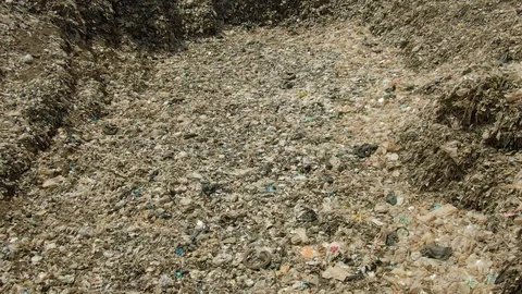 City dump, People are sorting garbage at the job site, aerial view. Stock Footage 107867808