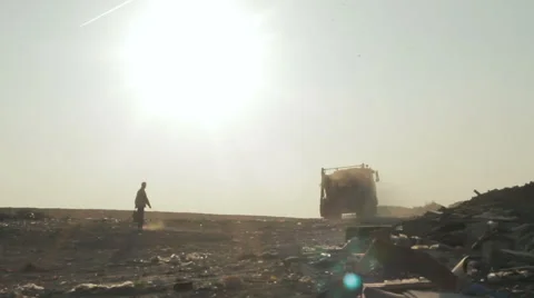 City dump.man preparing the machine for loading debris. backlight. Minsk city Stock Footage 68861424