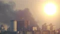 The city fire with a black smoke on the bright sun background 4k or 4k+ Resolution