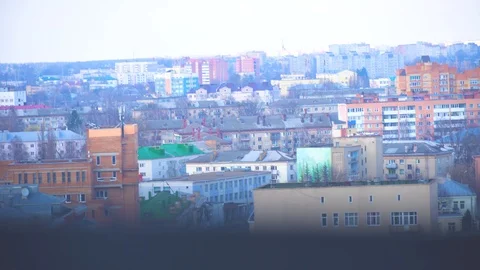 A city from a great height, the camera moves from the city to a young man, . Stock Footage 106676106