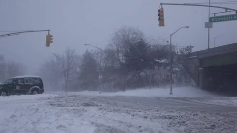 City intersection during a blizzard with swirling snow Stock Footage 73675550