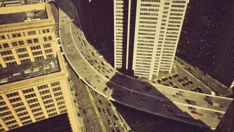 City intersection at dusk with vibrant traffic and shimmering illumination Stock Footage 335595531