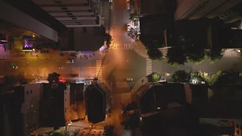 City intersection at night with traffic lights and illuminated streets Stock Footage 297927262