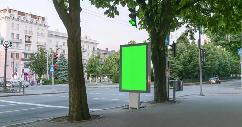 City light vitrine with empty green screen chroma key on roadside against cars Stock Footage 130939558