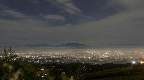 City-lights-and-mountain-range-at-night-landscape Stock Photos