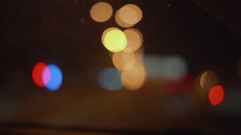The city lights at night through a car windshield in a blur. Stock Footage