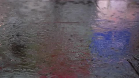 City lights reflected on the pavement of generic city on a rainy night Vídeo Stock 132426704