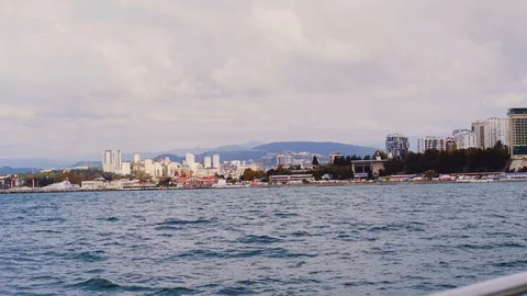 City located on the seafront. View from the boat swinging on the waves. Stock Footage 107031429
