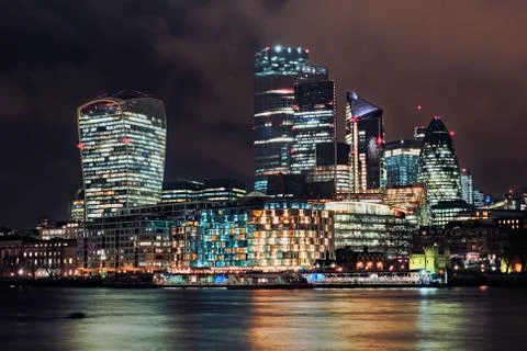 City of London at night with the Thames river Stock Photos