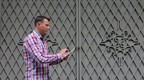 In the City Man Uses Tablet Stock Footage 63546609