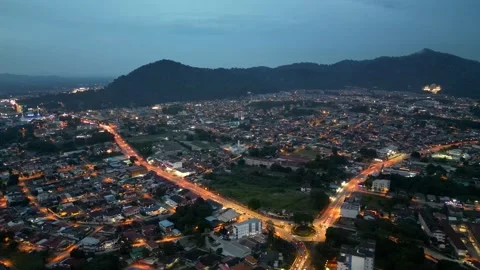 A city at night with a mountain in the background. 스톡 동영상 325824934