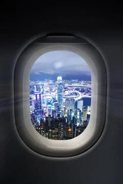 City at night through airplane window Stock Photos