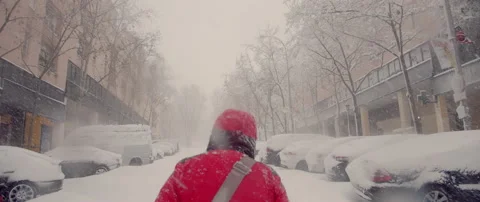 City paralyzed massive blizzard. Walker advances in snowstorm Stock Footage 148379892