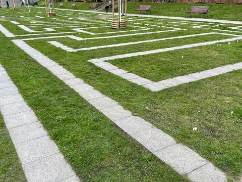In the city park, the paths are lined with a labyrinth for children's games Stock Photos