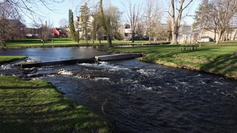 City park with small river in spring. Stewart Park In Perth, Ontario, Canada Video stock 327432705