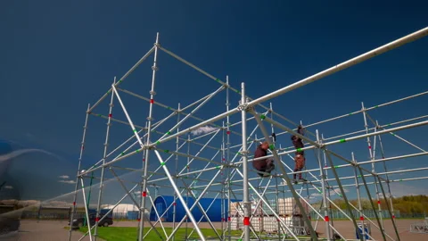 City people on stage framework construction process panorama timelapse 4k Stock Footage 162136222
