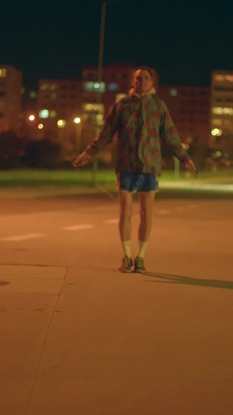 City performer at night maintains consistent beat with warm glow Stock Footage 324592529