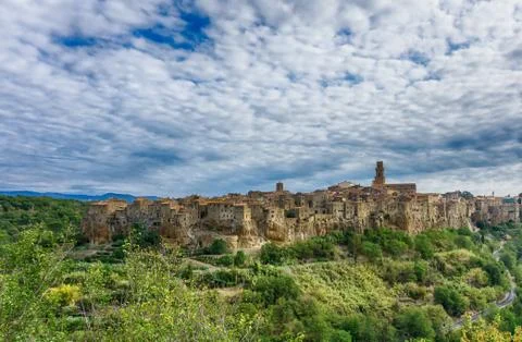 City of Pitigliano under cloudy dramatic sky Stock Photos