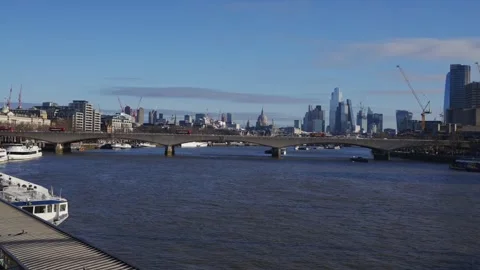 A city with a river running through it and a bridge over the water Stock Footage 297860250