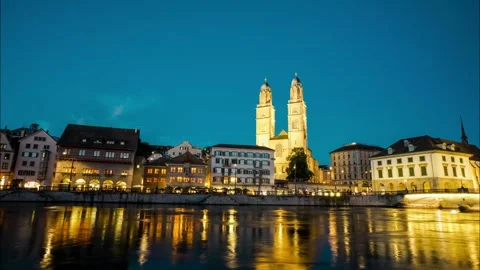 A city with a river running through it and a large church in the background Stock Footage 313554581