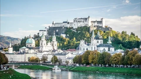 A city with a river running through it and a large castle in the background Stock Footage 313603361