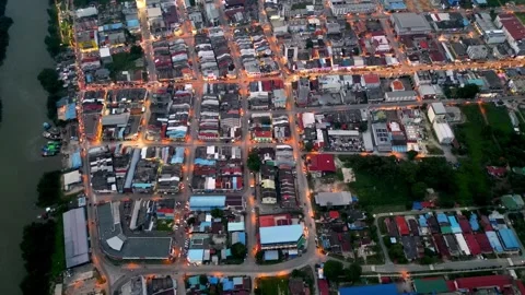 A city with a river running through it. Aerial Batu Pahat town in night Видео 325842573
