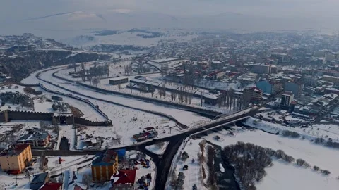 A city with a river running through it and snow on the ground Stock Footage 328246993