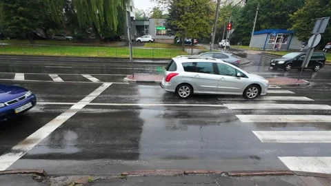 City road intersection during rain. Movement of cars on city roads and streets.  Stock-Footage 316520669