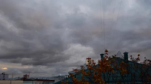 City roofs and while evening becoming with greey clouds timelaps Stock Footage 68442121