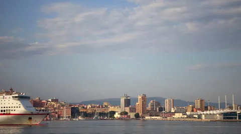 City scape of Cagliari at sunset while a ferry boat crossing the sea. Stock-Footage 60997542