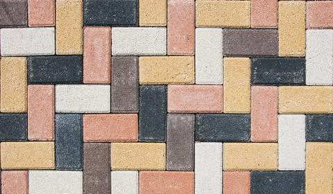 The city sidewalk is lined with multi-colored road tiles. View from above. Stock Photos