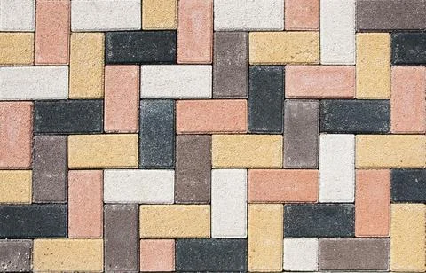 The city sidewalk is lined with multi-colored road tiles. View from above. Stock Photos