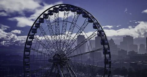 City skyline features a large ferris wheel during dusk with clouds Stock Illustration
