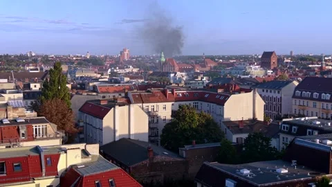 City skyline with large fire smoke plume rising. Smooth aerial view drone Stock Footage 345336892