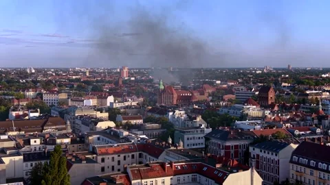 City skyline with large fire smoke plume rising. Dramatic aerial view drone Stock Footage 345337072
