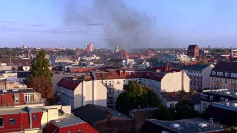 City skyline with large fire smoke plume rising. Fantastic aerial view drone Stock Footage 345337149