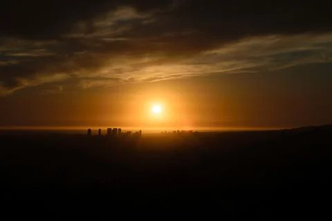 City skyline at sunset with dramatic clouds Stock Photos