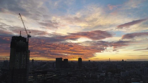 City skyline sunset panning down to busy city streets below, drone aerial 4K Stock Footage 101160229