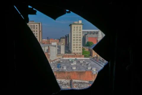 A City Skyline Through a Sharp Hole in a Wall Stock Photos