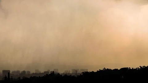 City skyline time lapse under heavy rain storm, sunset with yellow sky Stock Footage 86529693