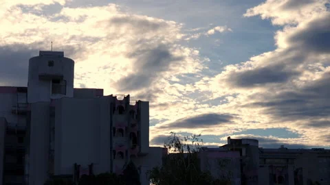 City skyline under dramatic sky. Silhouettes of tall buildings against clouds in Stock Footage 218994952