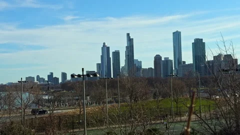 City skyline view in Chicago during a clear day with trees and pathways visible Stock Footage 332046947