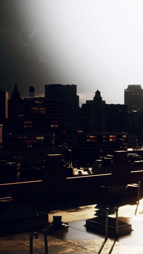 City skyline view during sunset from a rooftop with dark clouds and lights Stock Footage 338417835