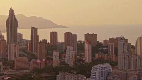 City skyline view at sunset over water with mountains in background and bui.. Stock Footage 340192884