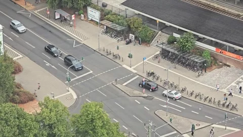 City street intersection and bicycle parking near a station in Cologne Stock Footage 345095133