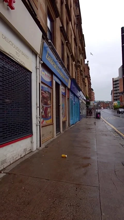 A city street lined with small stores - Vertical Video Stock Footage 200401422