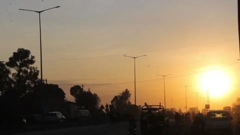 City sunset along the road while people and vehcles moving Stock Footage 162235060