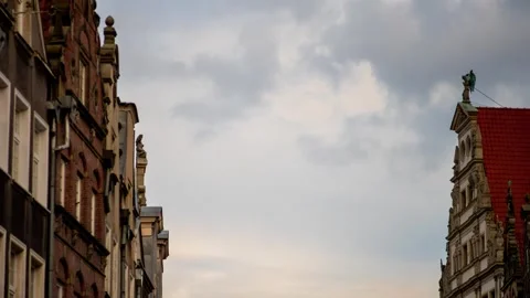City time lapse fast moving clouds on sky between high vintage gothic style Stock Footage 253281264
