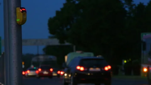 City traffic at evening, wait button crosswalk close up yellow and cars lights Stock Footage 109001393