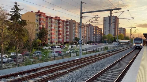City train arrives at the platform in the evening light. - stock video Stock Footage 240342047